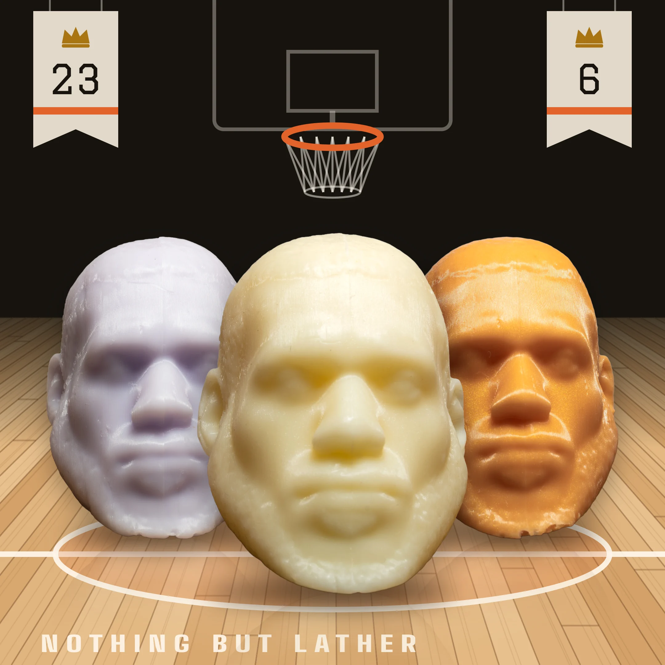 Three LeSoap bars, Lavender, Honey and Tangerine Lychee, standing at centre court on a hardwood floor under a basketball hoop